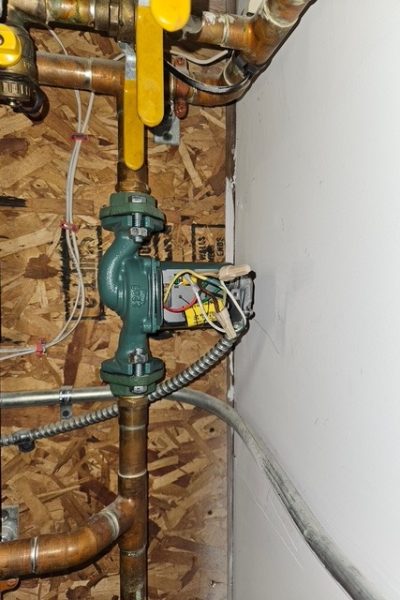 Green circulator pump with copper piping