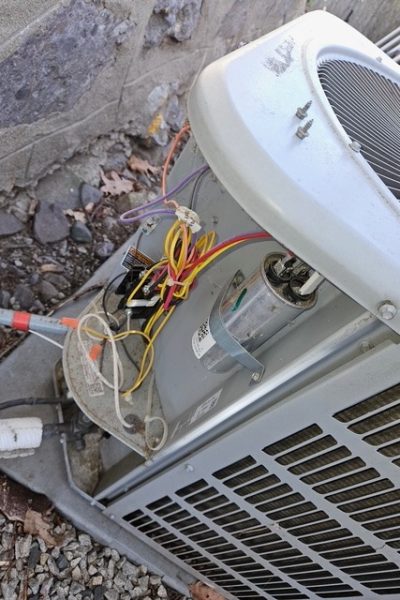 Outdoor air conditioning unit with exposed wiring