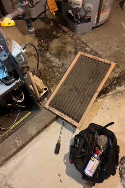 Dirty furnace filter beside tool bag