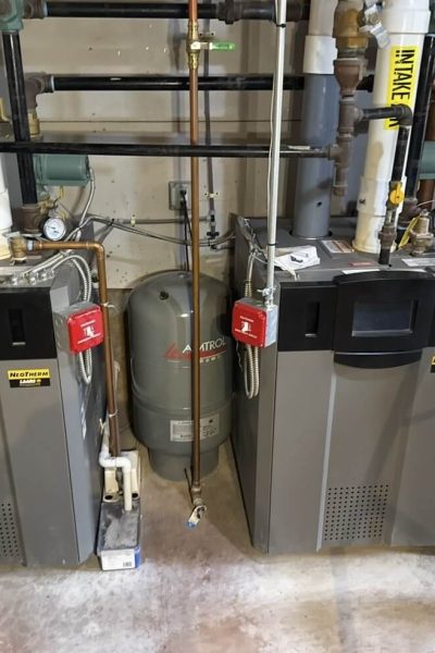 Two commercial boilers with piping and valves