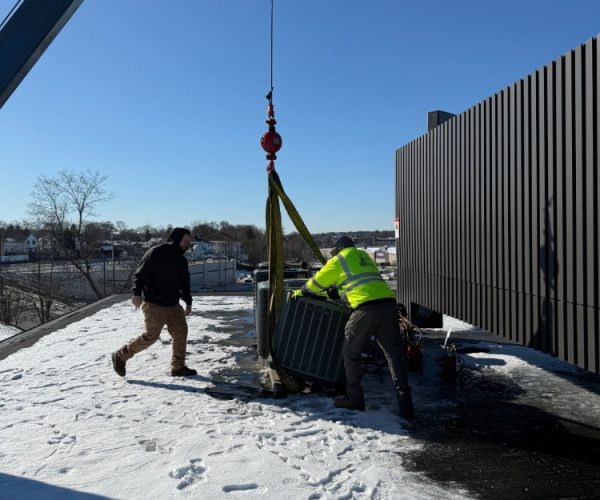 A crane is lifting a metal fence. A crane is lifting a metal fence.