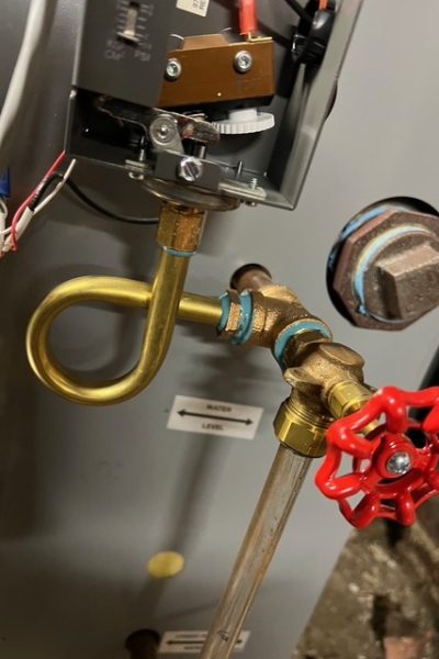 Brass loop tubing with red-handled valve