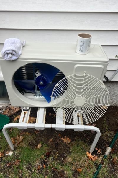 Outdoor air conditioning unit with exposed fan