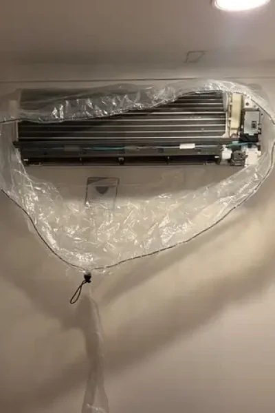 Wall-mounted air conditioner wrapped for cleaning