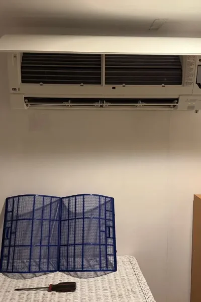 Wall-mounted air conditioner above bed with filters